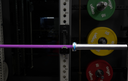 Purple barbell on a weight rack with colorful weight plates.