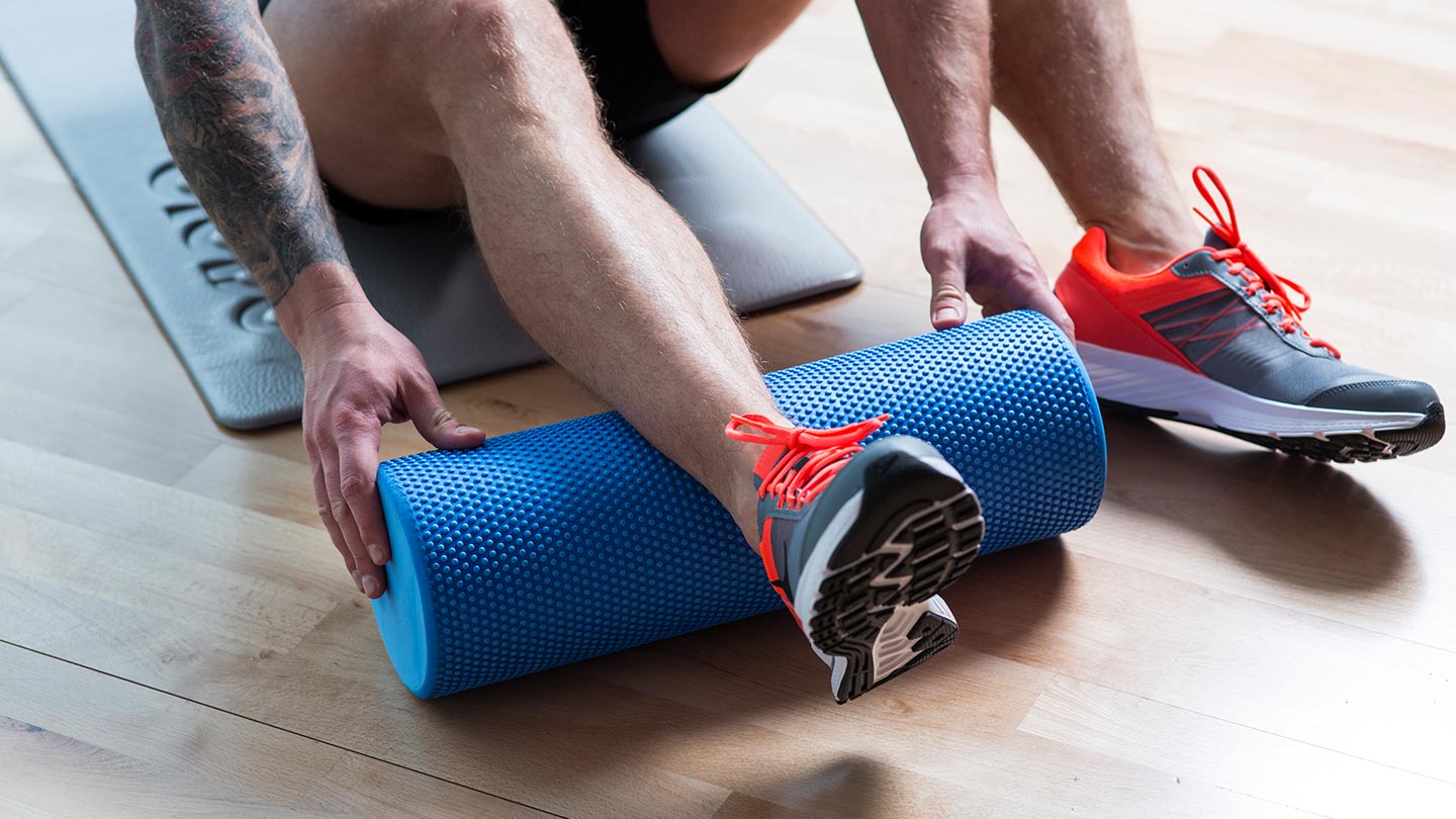 man with foam roller for trigger-point release