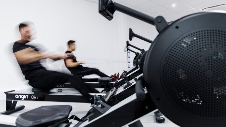 two members on a rowing machine