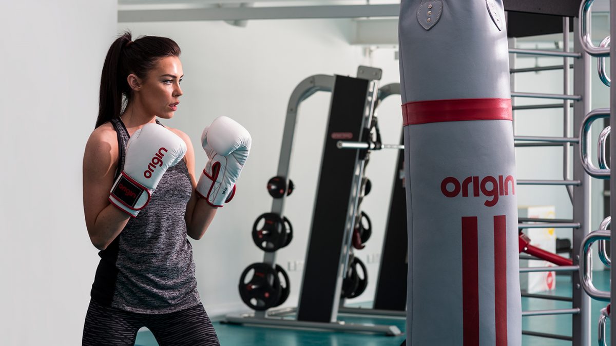 girl exercising with boxing bag